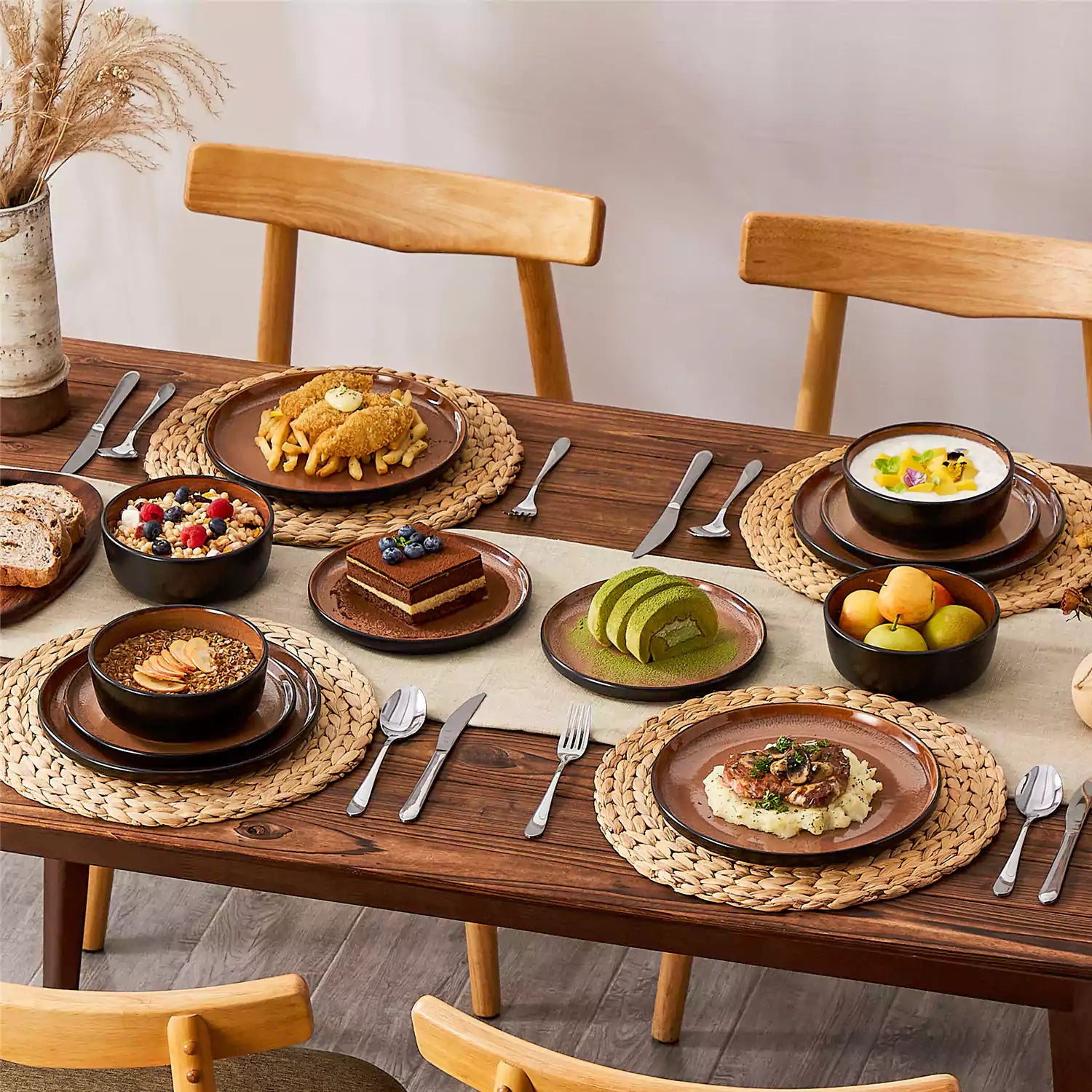Rustic dining table with Amber 12-piece stoneware dinnerware in farmhouse red - featuring reactive glaze plates - bowls - and utensils by vancasso