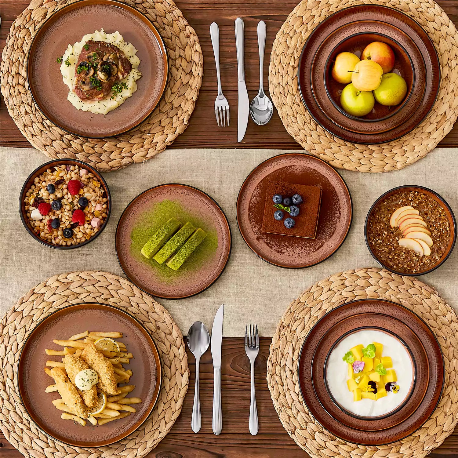 Rustic dining table with Amber 12-piece stoneware dinnerware in farmhouse red - featuring reactive glaze plates - bowls - and utensils by vancasso