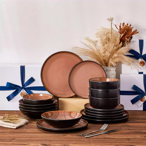 Assorted dishes with soup - dessert - and fruit salad on rustic wooden table - Amber 16-Piece red stoneware dinnerware set with plates and bowls by vancasso