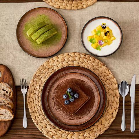 Assorted dishes with soup - dessert - and fruit salad on rustic wooden table - Amber 16-Piece red stoneware dinnerware set with plates and bowls by vancasso