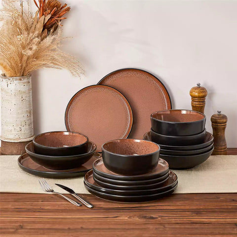 Assorted dishes with soup - dessert - and fruit salad on rustic wooden table - Amber 16-Piece red stoneware dinnerware set with plates and bowls by vancasso