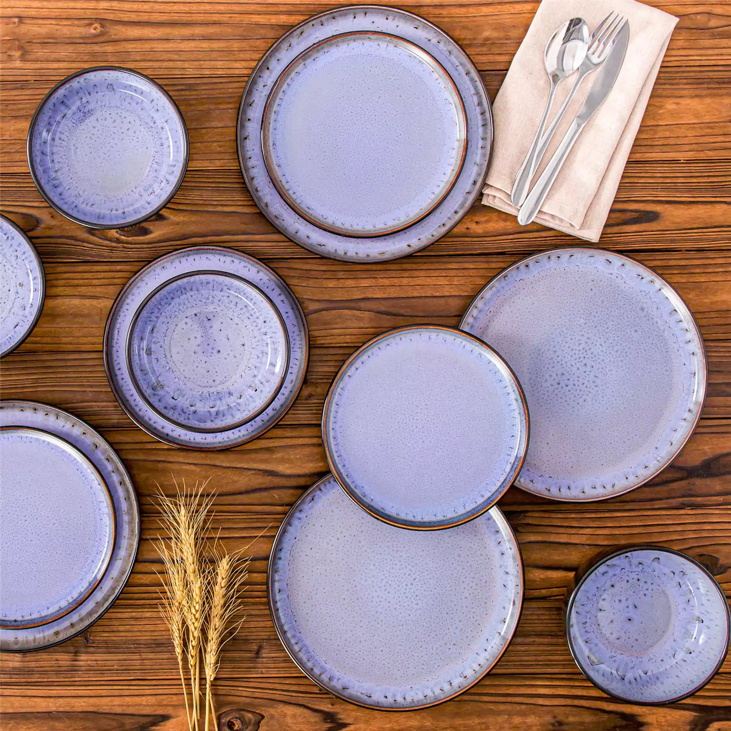 Rustic dining table with Amber 12-piece stoneware dinnerware in farmhouse violet - featuring reactive glaze plates - bowls - and utensils by vancasso
