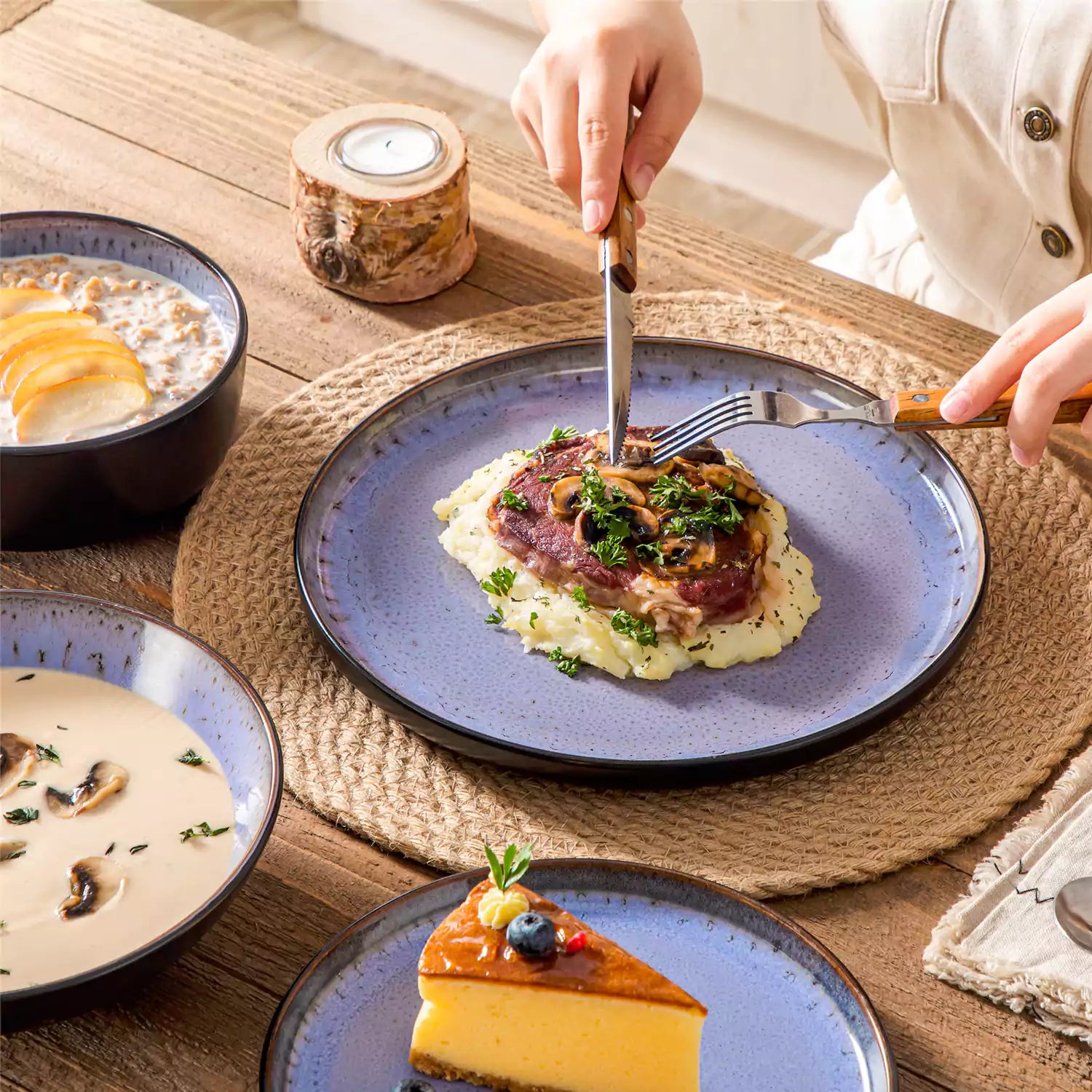 Assorted dishes with soup - dessert - and fruit salad on rustic wooden table - Amber 16-Piece violet stoneware dinnerware set with plates and bowls by vancasso