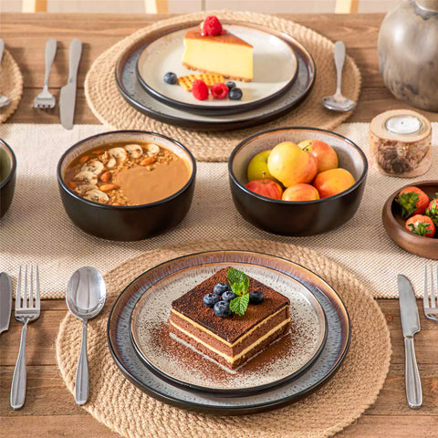 Rustic dining table with Amber 12-piece stoneware dinnerware in farmhouse beige - featuring reactive glaze plates - bowls - and utensils by vancasso