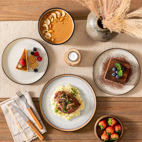 Rustic dining table with Amber 12-piece stoneware dinnerware in farmhouse beige - featuring reactive glaze plates - bowls - and utensils by vancasso