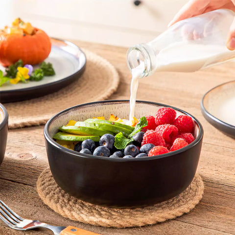 Rustic dining table with Amber 12-piece stoneware dinnerware in farmhouse violet - featuring reactive glaze plates - bowls - and utensils by vancasso
