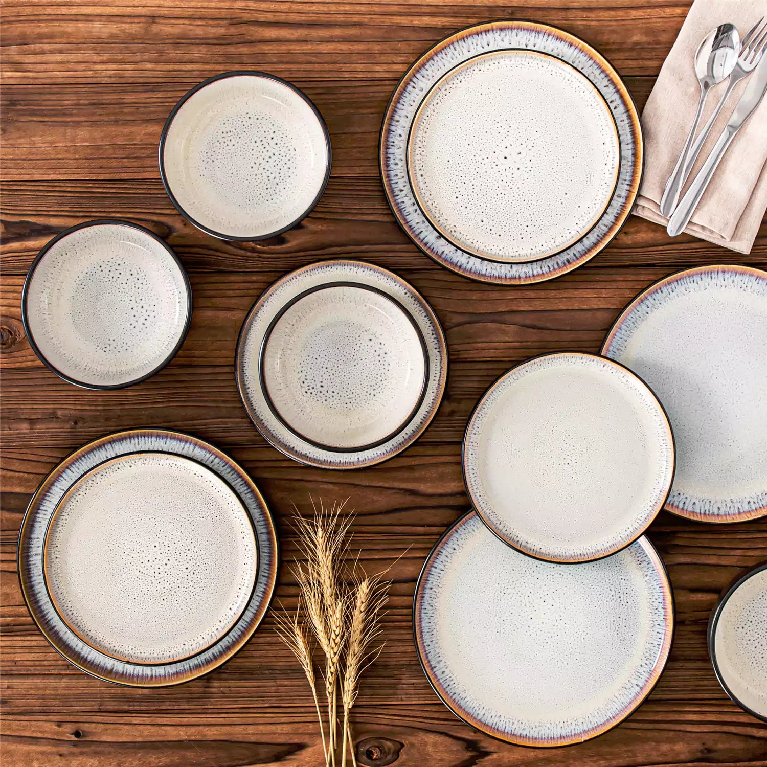 Rustic dining table with Amber 12-piece stoneware dinnerware in farmhouse beige - featuring reactive glaze plates - bowls - and utensils by vancasso