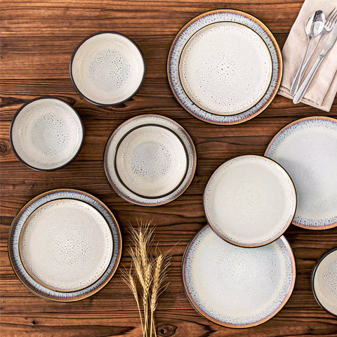 Rustic dining table with Amber 12-piece stoneware dinnerware in farmhouse beige - featuring reactive glaze plates - bowls - and utensils by vancasso