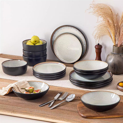 Assorted dishes with soup - dessert - and fruit salad on rustic wooden table - Amber 16-Piece beige stoneware dinnerware set with plates and bowls by vancasso