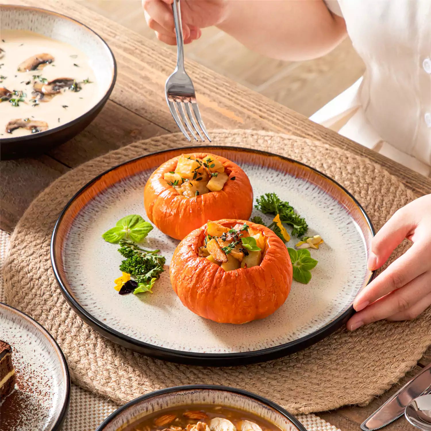 Assorted dishes with soup - dessert - and fruit salad on rustic wooden table - Amber 16-Piece beige stoneware dinnerware set with plates and bowls by vancasso