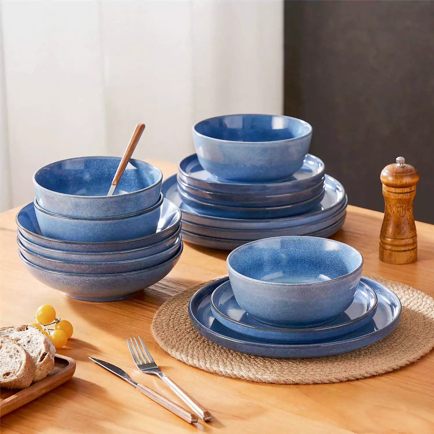Handcrafted blue stoneware with reactive glaze on woven placemats - perfect for farmhouse tables