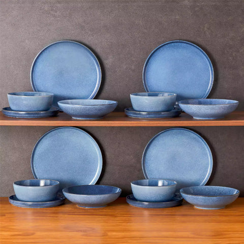 Handcrafted blue stoneware with reactive glaze on woven placemats - perfect for farmhouse tables