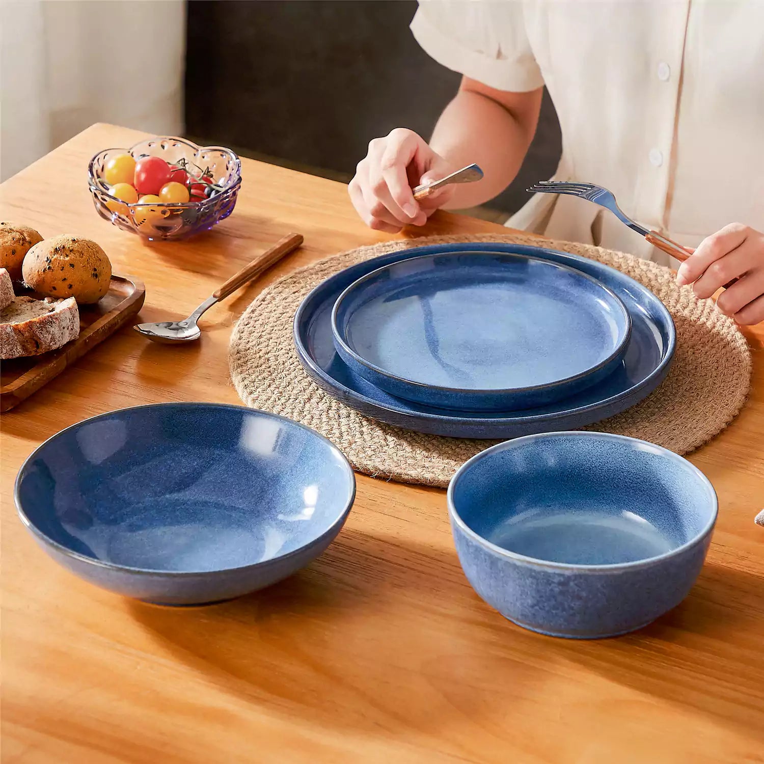 Handcrafted blue stoneware with reactive glaze on woven placemats - perfect for farmhouse tables