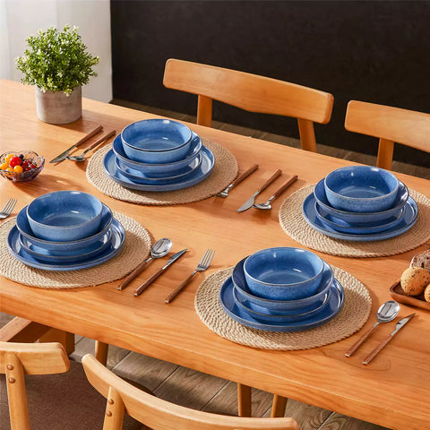 Handcrafted blue stoneware with reactive glaze on woven placemats - perfect for farmhouse tables