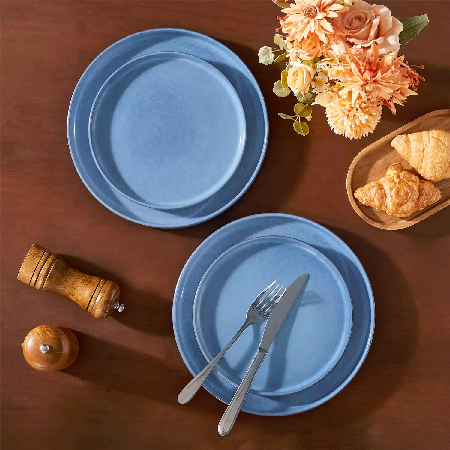 Anya 16 piece straight edge stoneware dinner set in blue with pasta soup and pastries on a modern farmhouse table