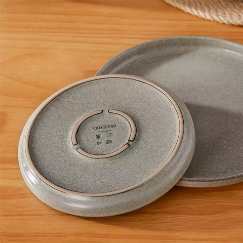 Handcrafted brown stoneware with reactive glaze on woven placemats - perfect for farmhouse tables