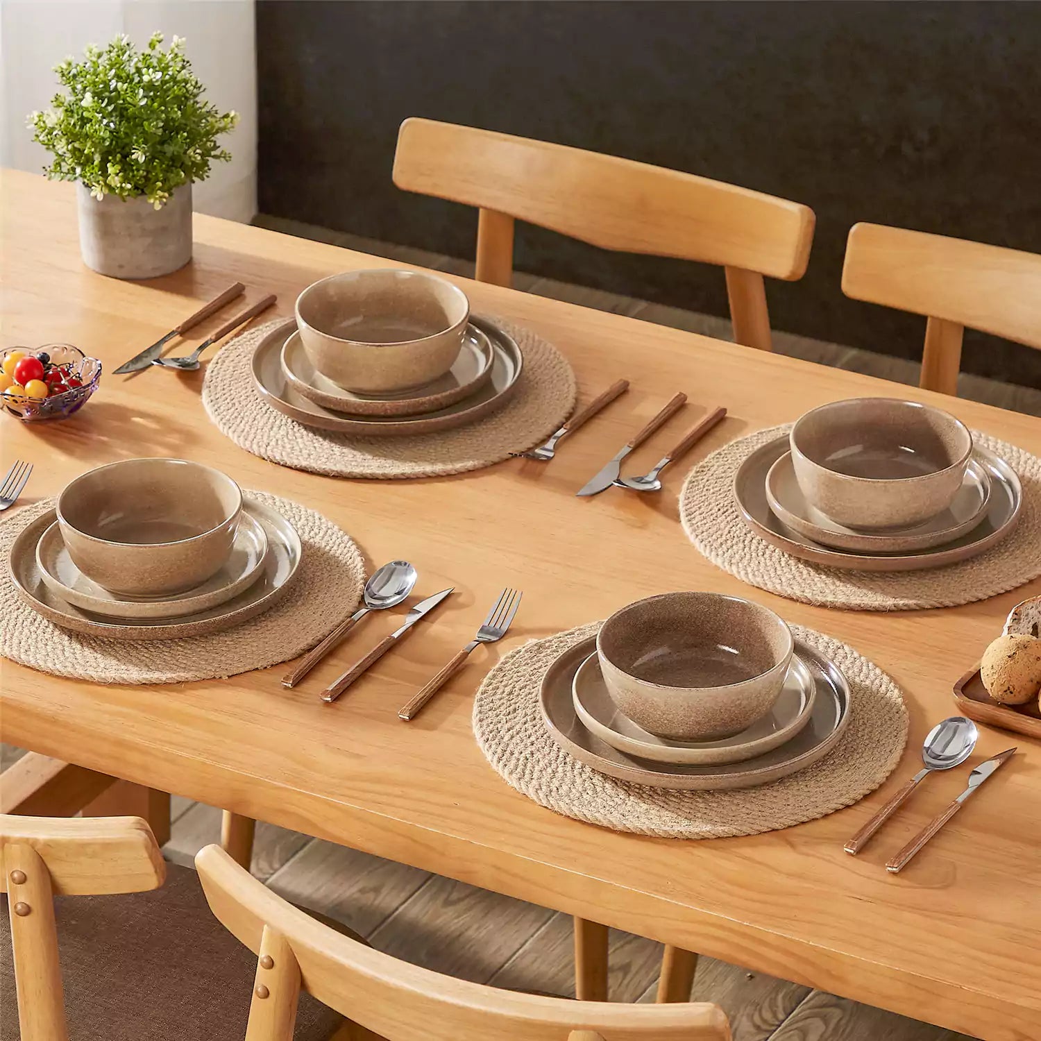 Caramel stoneware plates and bowls with reactive glaze on farmhouse wooden table with woven placemats