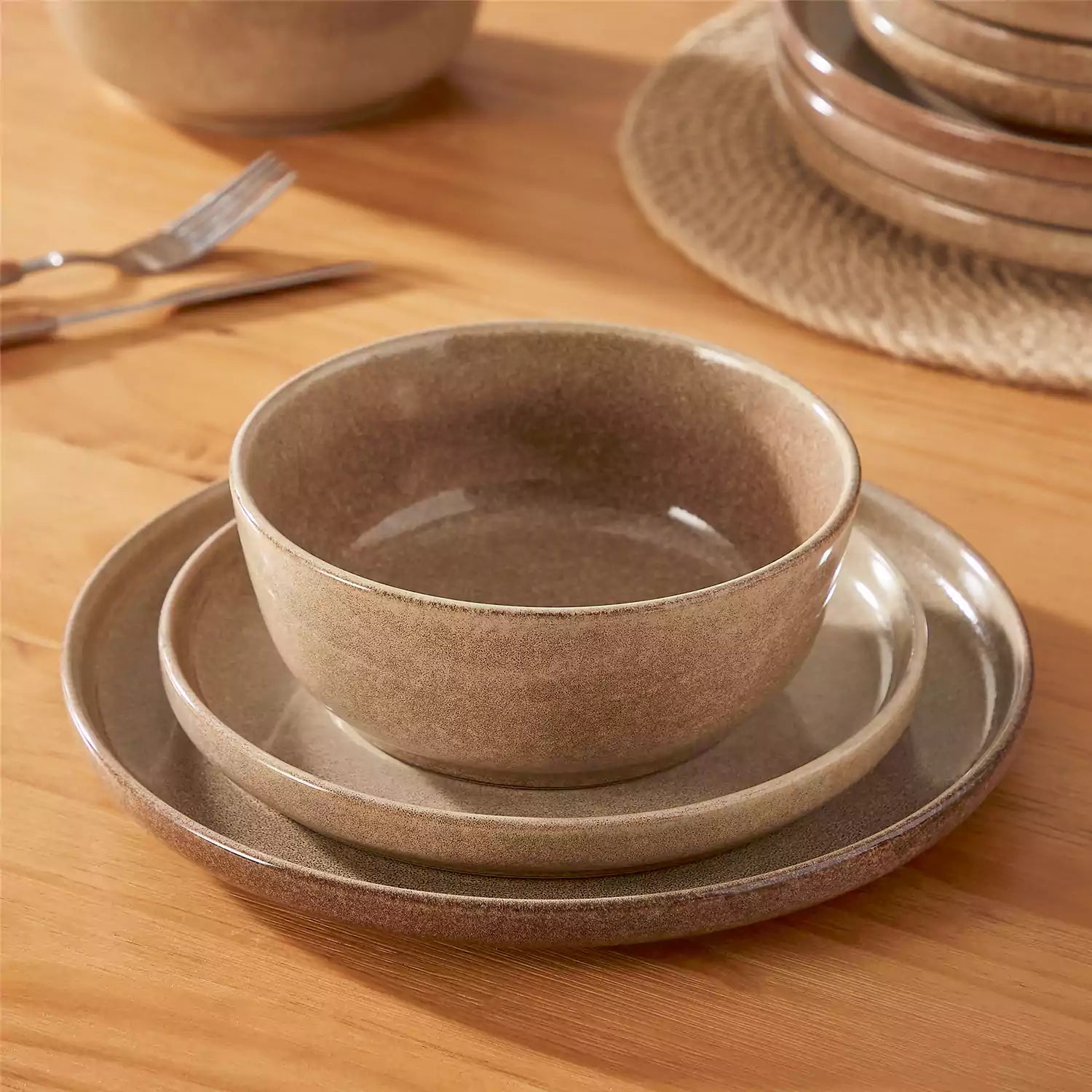 Handcrafted caramel stoneware with reactive glaze on woven placemats - perfect for farmhouse tables