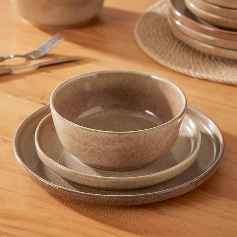 Handcrafted caramel stoneware with reactive glaze on woven placemats - perfect for farmhouse tables