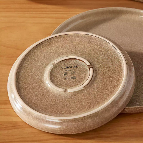 Handcrafted caramel stoneware with reactive glaze on woven placemats - perfect for farmhouse tables