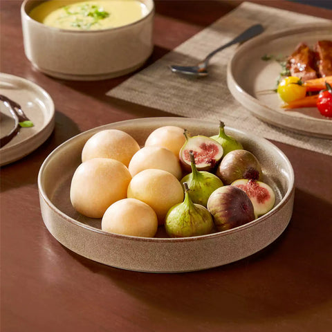 Anya 16 piece straight edge stoneware dinner set in caramel with pasta soup and pastries on a modern farmhouse table