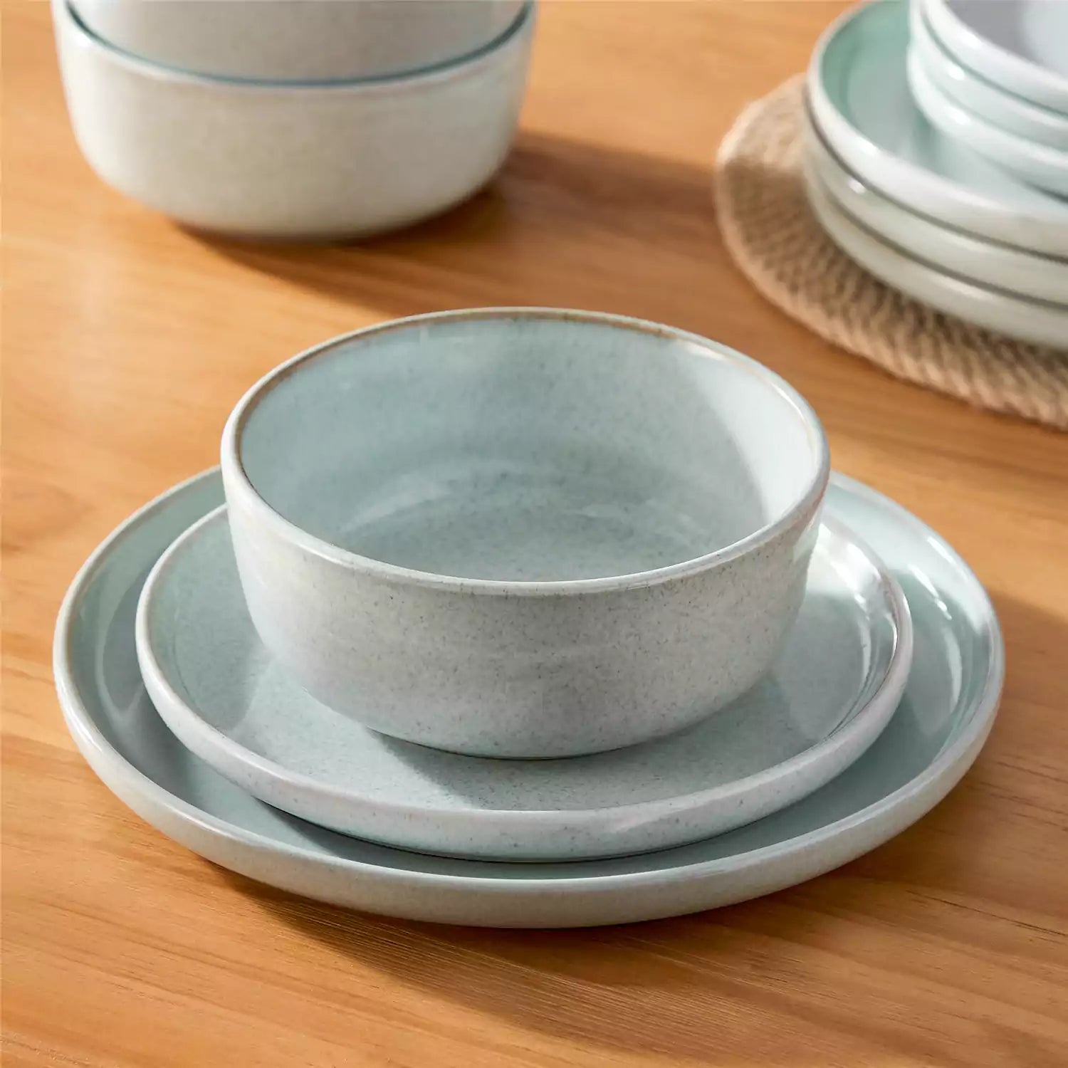 Handcrafted mint green stoneware with reactive glaze on woven placemats - perfect for farmhouse tables