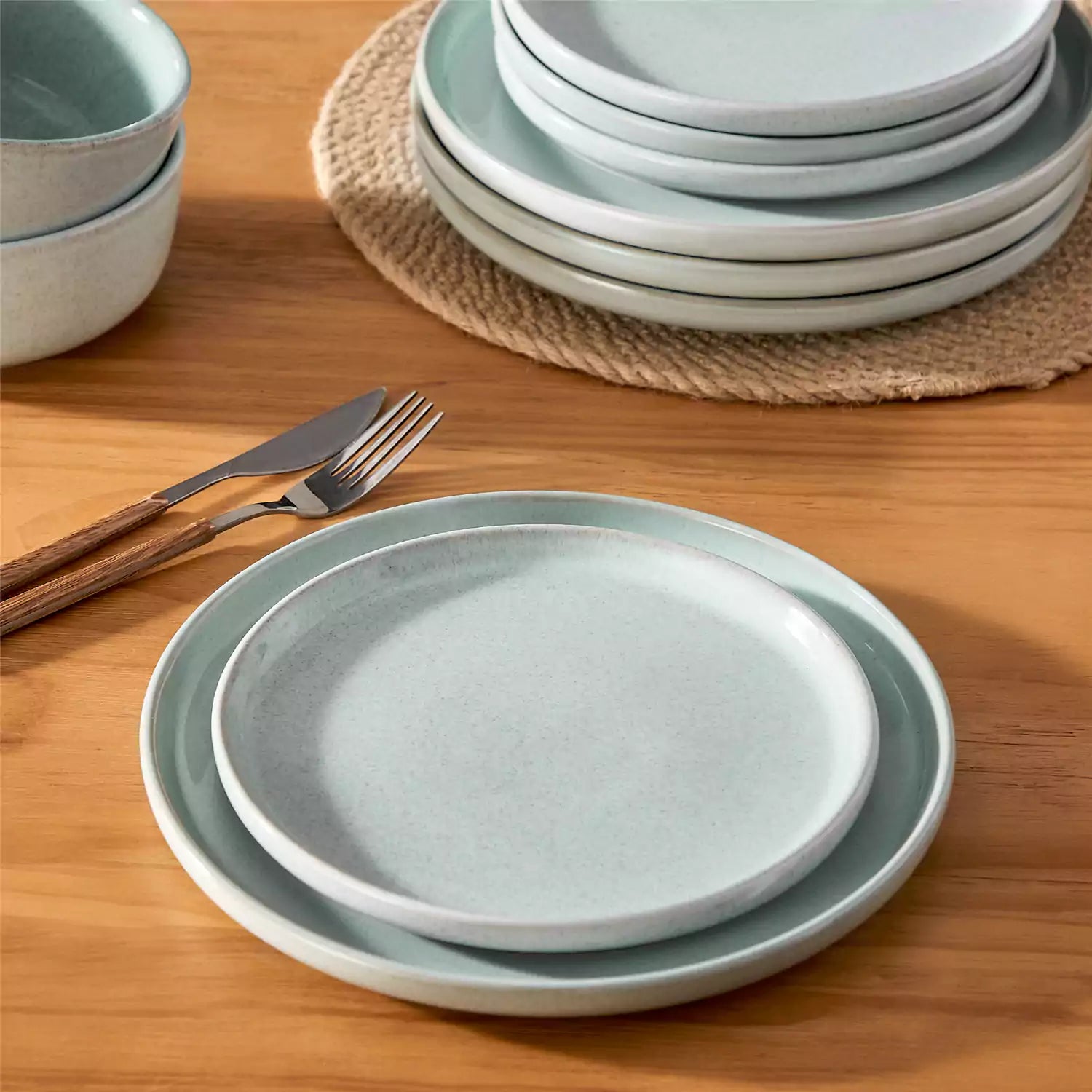Handcrafted mint green stoneware with reactive glaze on woven placemats - perfect for farmhouse tables