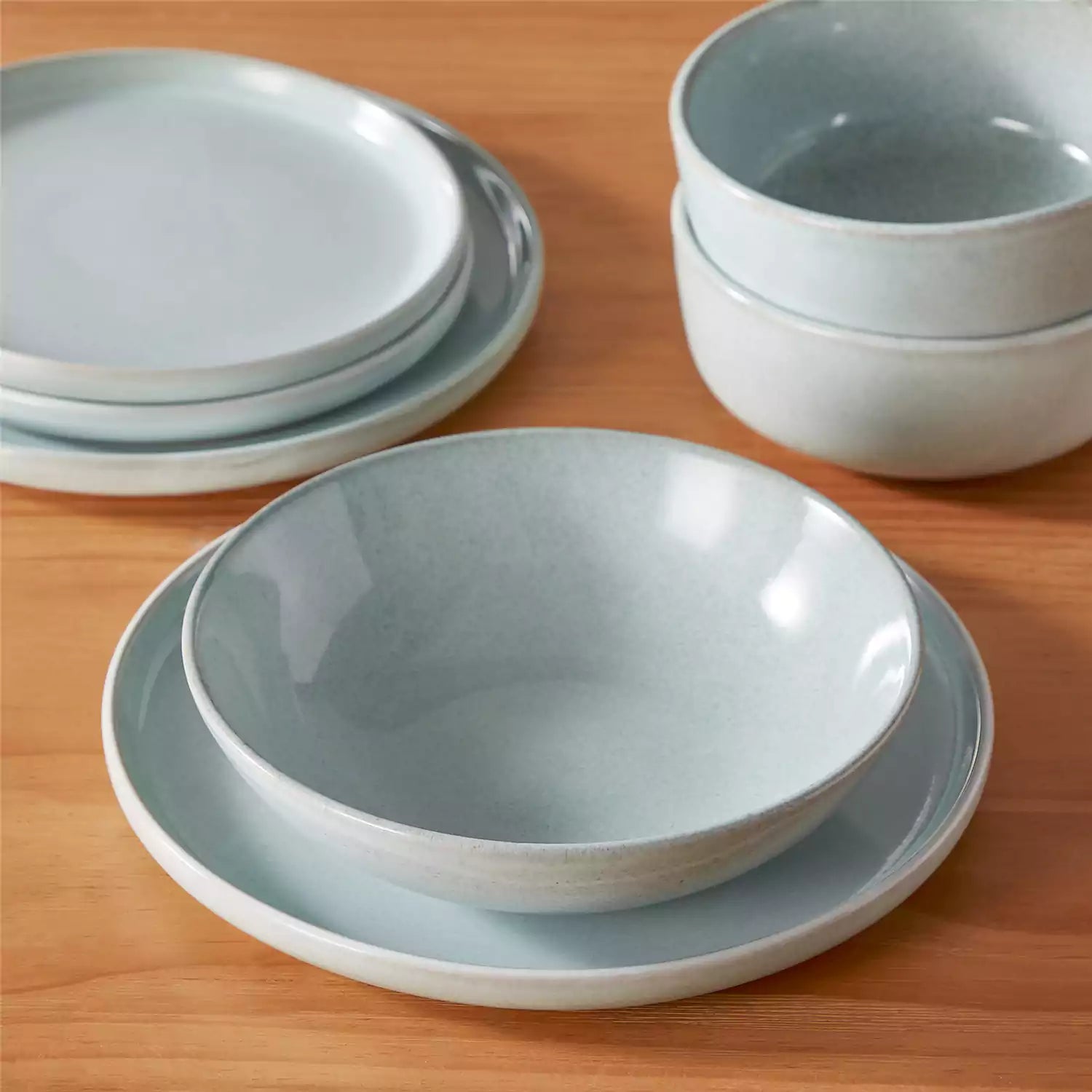 Handcrafted mint green stoneware with reactive glaze on woven placemats - perfect for farmhouse tables