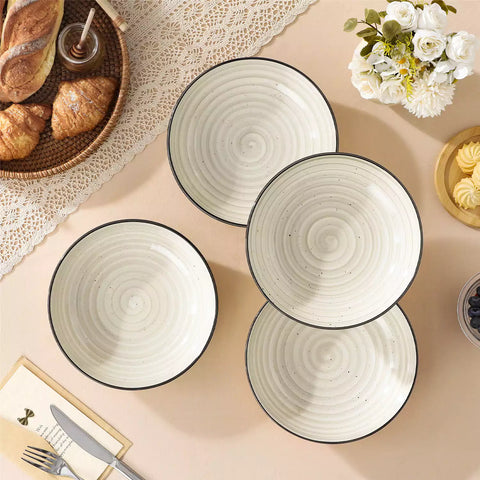 Bonbon stoneware pasta bowls in beige with spiral speckled glaze on a styled dining table