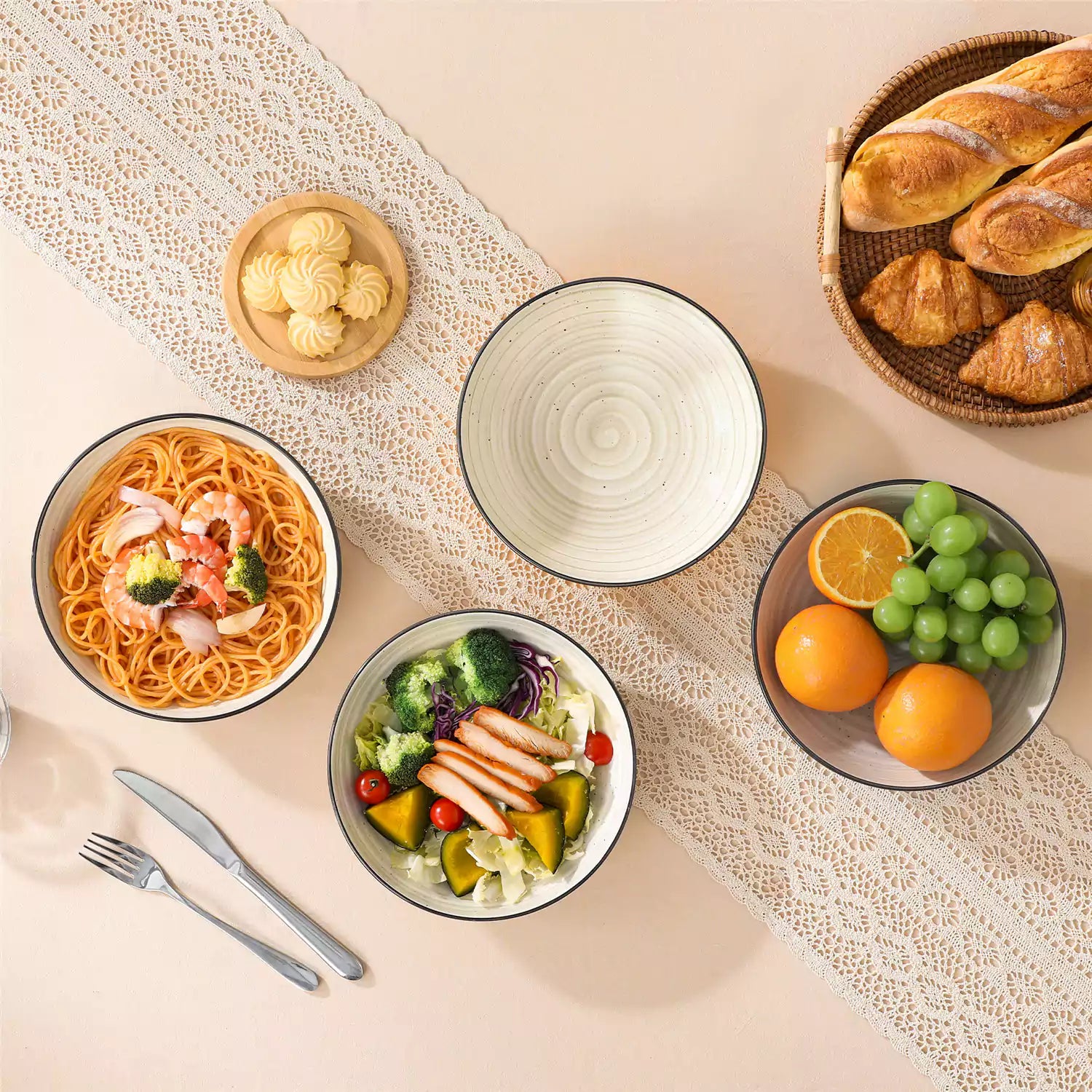 Bonbon stoneware pasta bowls in beige with spiral speckled glaze on a styled dining table