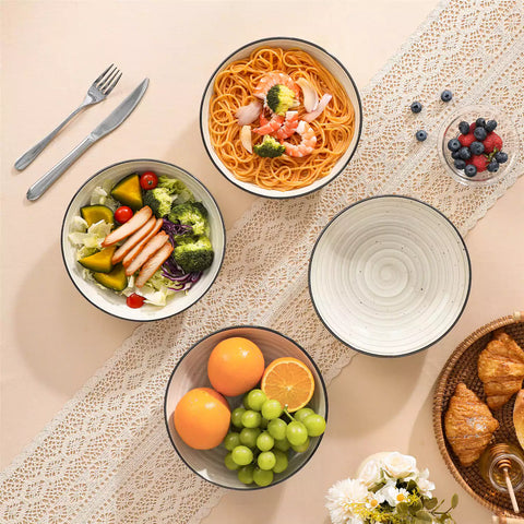 Bonbon stoneware pasta bowls in beige with spiral speckled glaze on a styled dining table