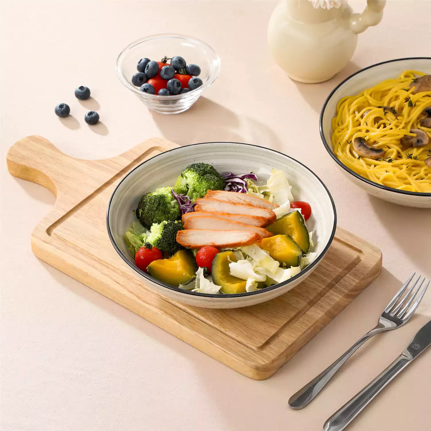 Bonbon stoneware pasta bowls in beige with spiral speckled glaze on a styled dining table