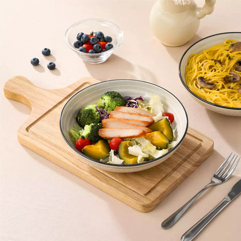 Bonbon stoneware pasta bowls in beige with spiral speckled glaze on a styled dining table