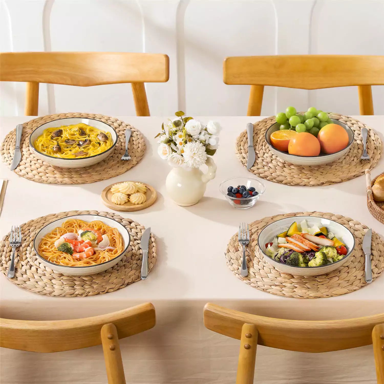 Bonbon stoneware pasta bowls in beige with spiral speckled glaze on a styled dining table