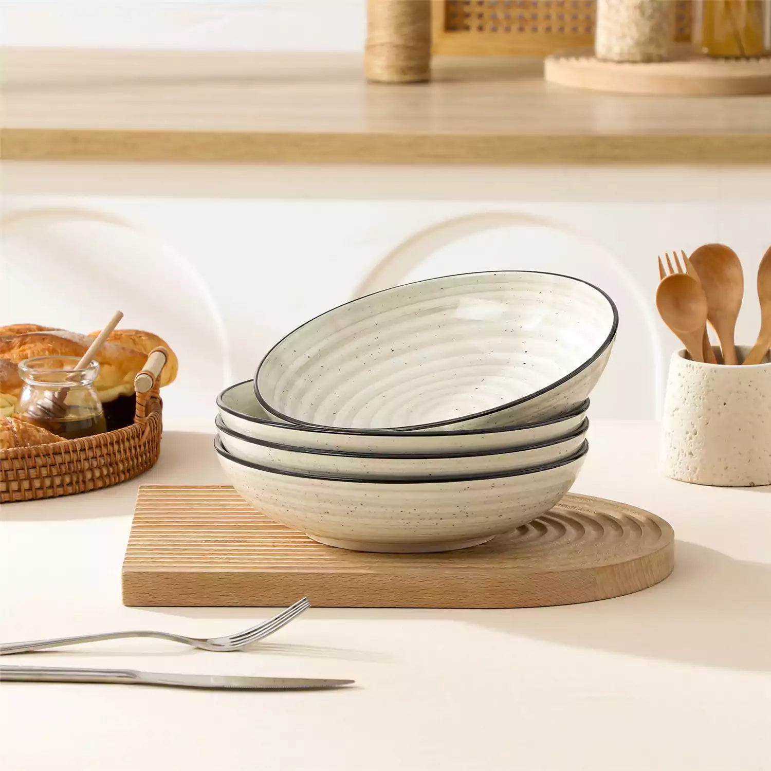 Bonbon stoneware pasta bowls in beige with spiral speckled glaze on a styled dining table