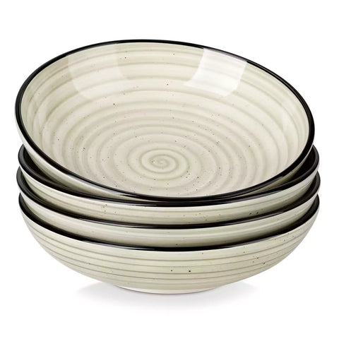 Bonbon stoneware pasta bowls in beige with spiral speckled glaze on a styled dining table