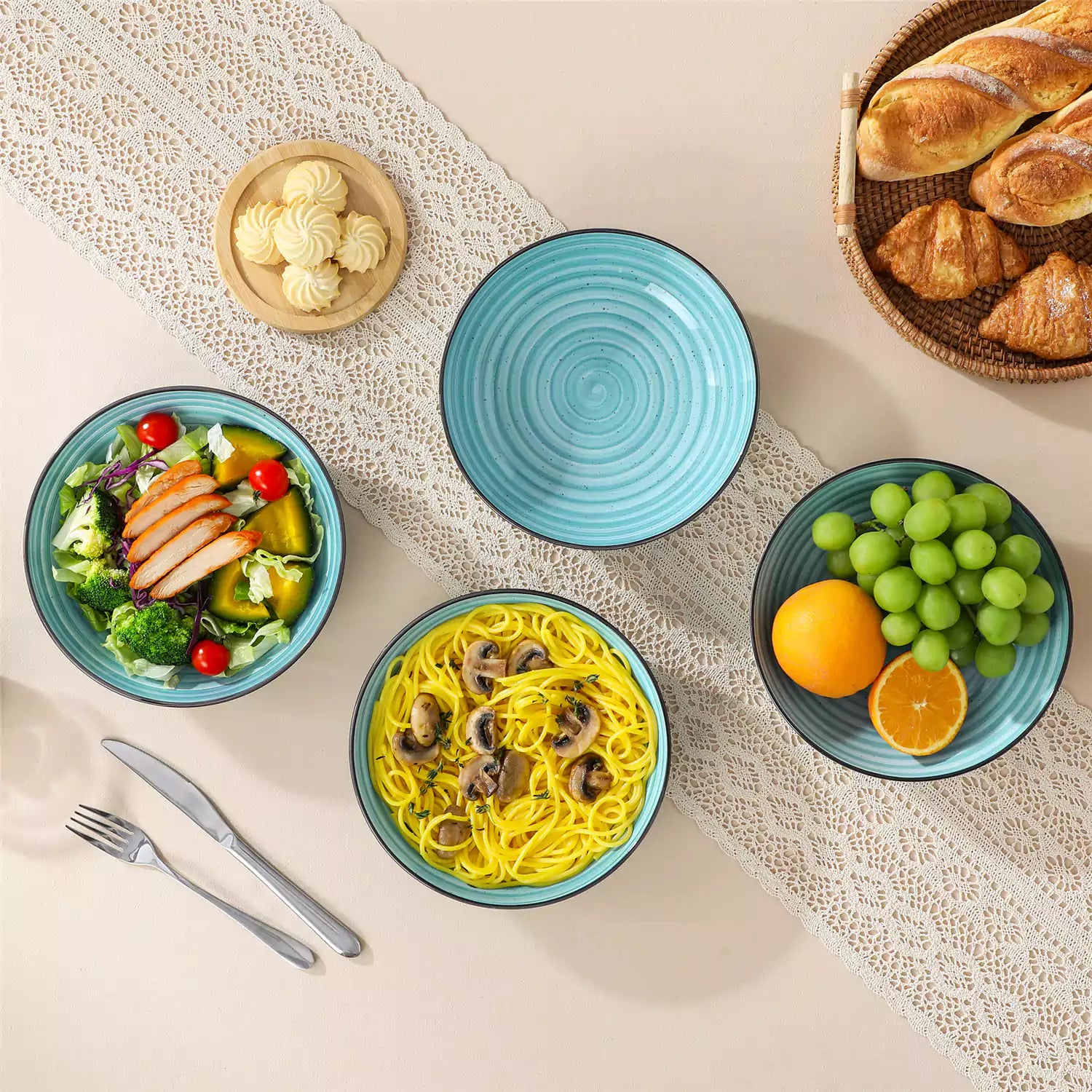 Bonbon stoneware pasta bowls in blue with spiral speckled glaze on a styled dining table