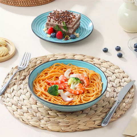 Bonbon stoneware pasta bowls in blue with spiral speckled glaze on a styled dining table