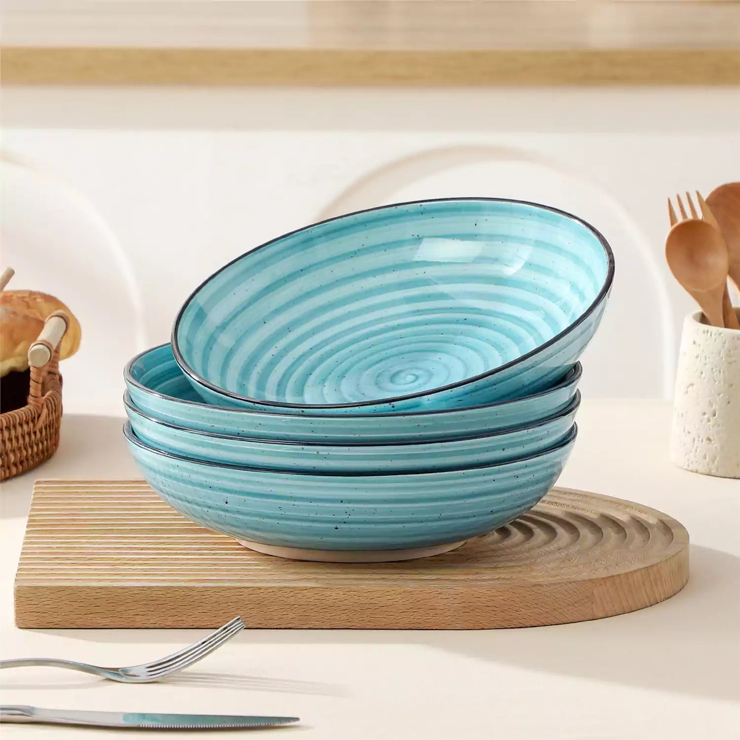 Bonbon stoneware pasta bowls in blue with spiral speckled glaze on a styled dining table