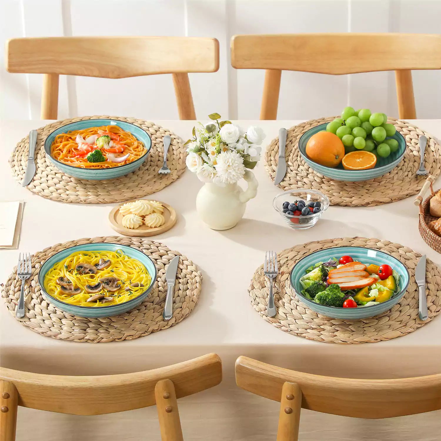 Bonbon stoneware pasta bowls in blue with spiral speckled glaze on a styled dining table