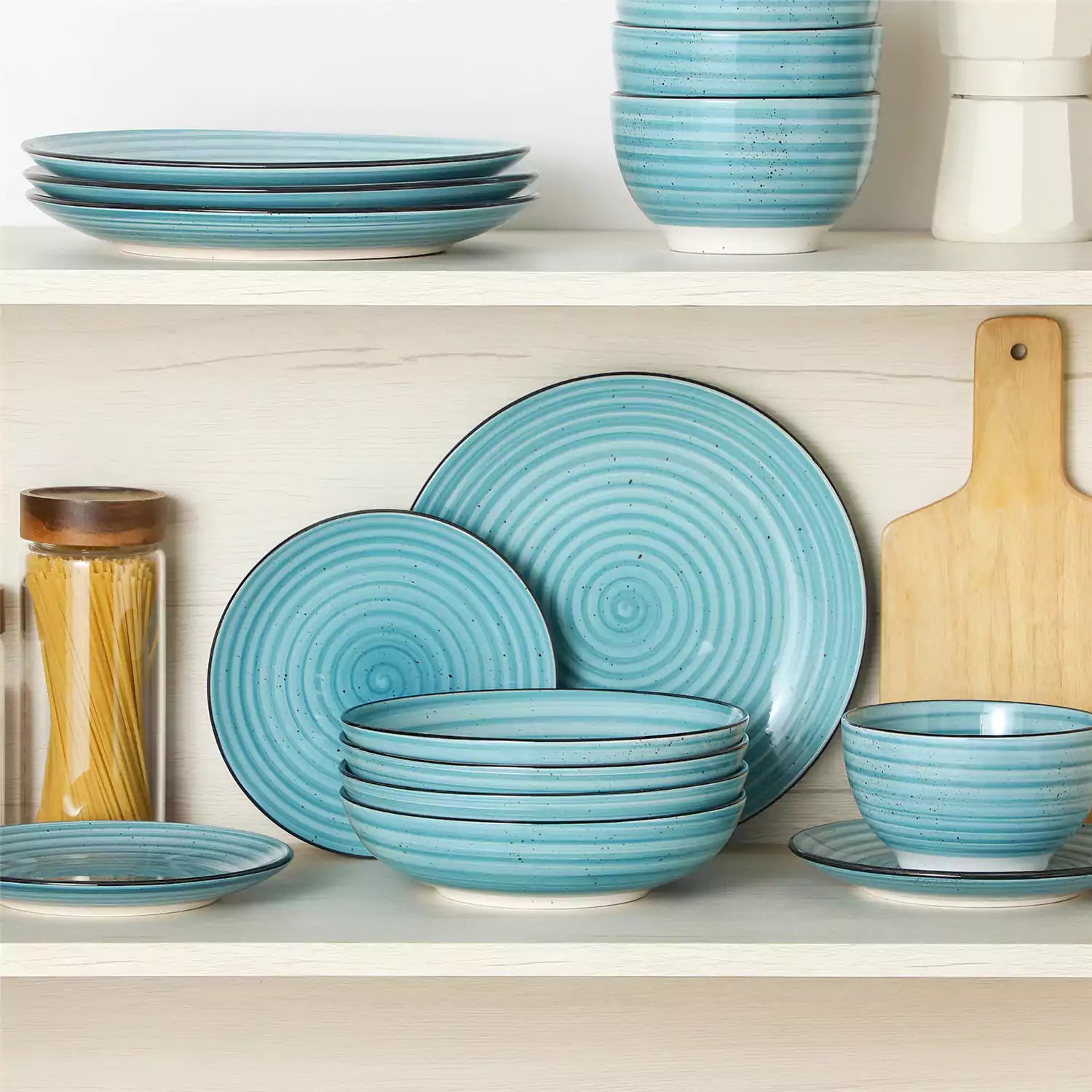 Bonbon stoneware pasta bowls in blue with spiral speckled glaze on a styled dining table