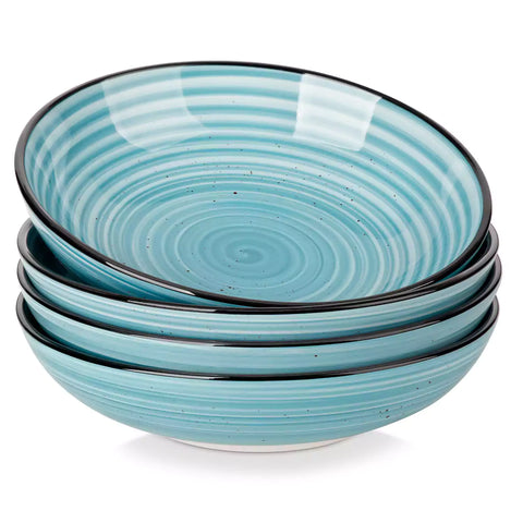 Bonbon stoneware pasta bowls in blue with spiral speckled glaze on a styled dining table