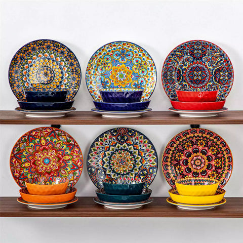 Lumi 24 piece porcelain dinnerware set with vibrant patterns stacked on a wooden table with colorful placemats and assorted dishes