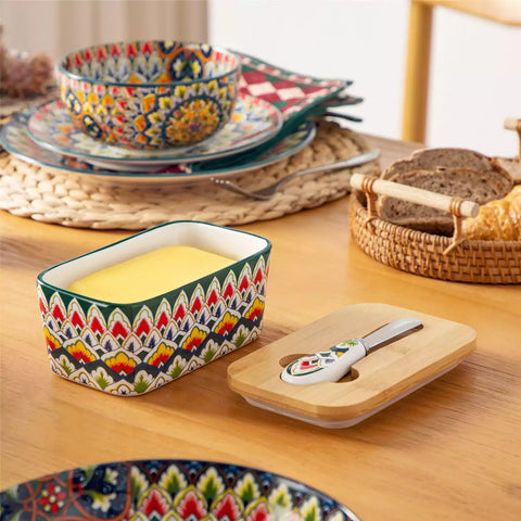 Lumi forest green porcelain butter dish with lid in vibrant Bohemian pattern on a wooden table
