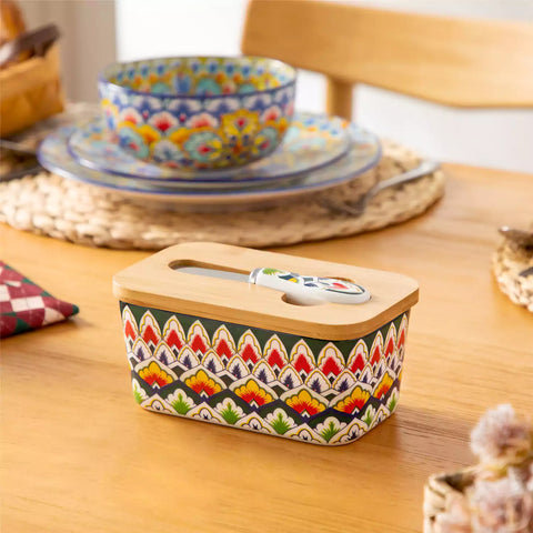 Lumi forest green porcelain butter dish with lid in vibrant Bohemian pattern on a wooden table