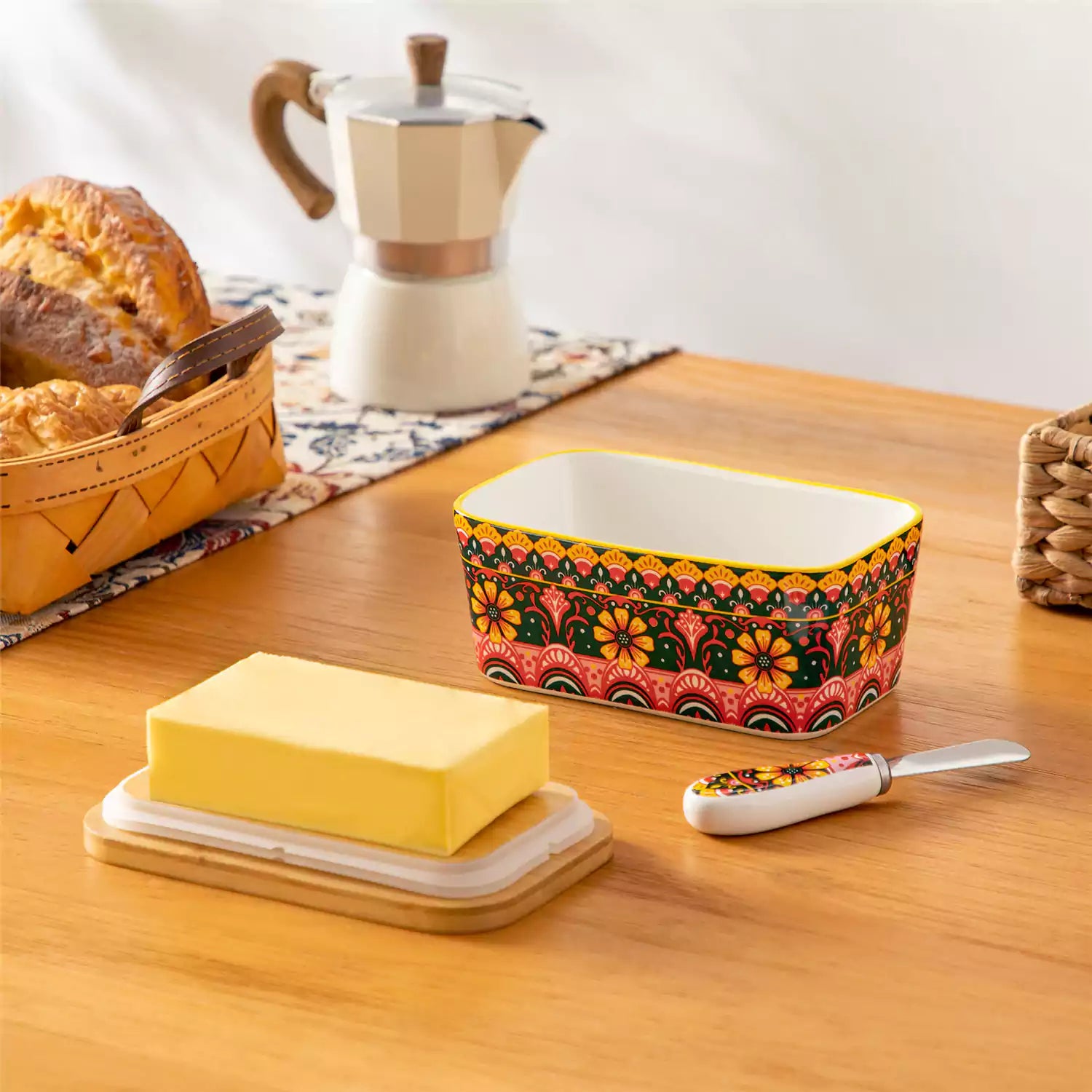 Lumi lemon yellow porcelain butter dish with lid in vibrant Bohemian pattern on a wooden table