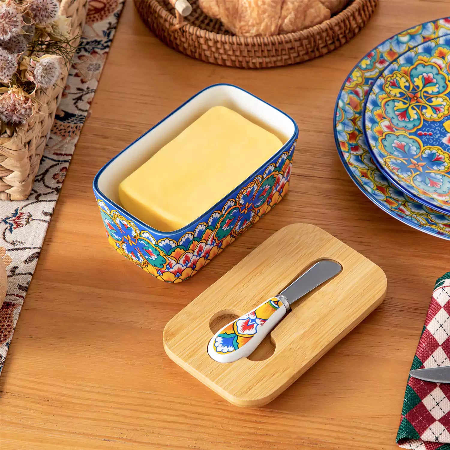 Lumi vibrant blue porcelain butter dish with lid in vibrant Bohemian pattern on a wooden table