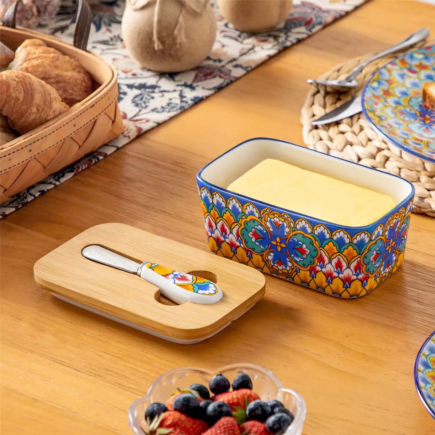 Lumi vibrant blue porcelain butter dish with lid in vibrant Bohemian pattern on a wooden table