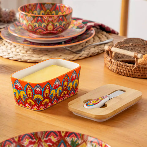 Lumi bold orange porcelain butter dish with lid in vibrant Bohemian pattern on a wooden table