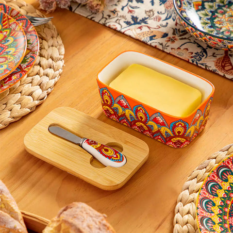 Lumi bold orange porcelain butter dish with lid in vibrant Bohemian pattern on a wooden table